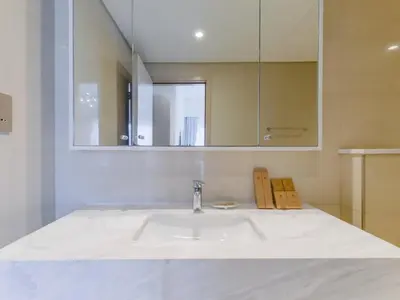 a bathroom with a sink and a mirror at TRPS - Burj Royale, Downtown Dubai - 2BR - Burj Khalifa View - Furnished & Ready in Dubai