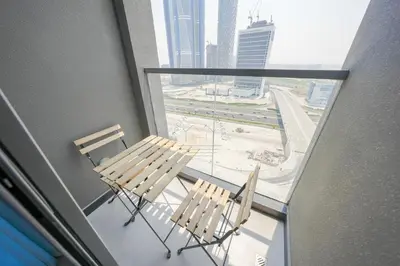 two chairs on a balcony with a view of a city at Stylish Retreat in Business Bay in Dubai