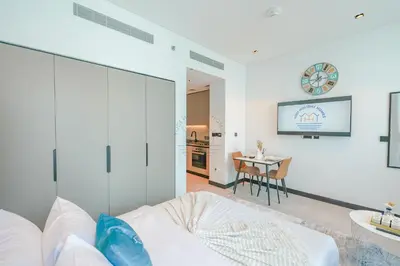 a white room with a bed and a table at Stylish Retreat in Business Bay in Dubai