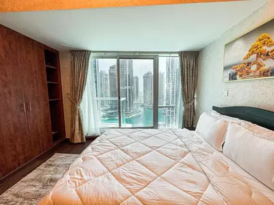a bedroom with a large bed with a large window at Fully Furnished Studio Lake Terrace, JLT Prime Location by Al sarya Holiday Homes in Dubai