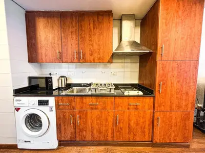 a kitchen with a sink and a washing machine at Fully Furnished Studio Lake Terrace, JLT Prime Location by Al sarya Holiday Homes in Dubai