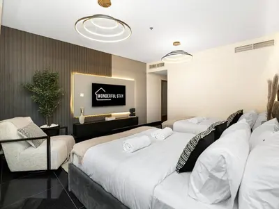 a hotel room with two beds and a tv at WonderfulStay at Marine Towers - Full Ain & Marina View - JBR Grande Living - Brand New Apartments in Dubai