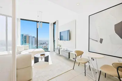 a living room with white furniture and a large window at High-Floor Luxury Spacious 1BR in Sobha Waves in Dubai