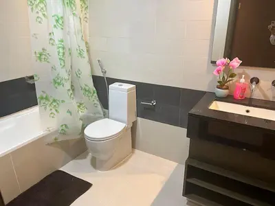 a bathroom with a white toilet and a sink at Elegant 1 Bedroom Apartment, The Lofts West Tower, Downtown Dubai By Al sarya Holiday Homes in Dubai