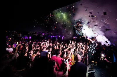 a crowd of people at a concert with a dj at FIVE Palm Jumeirah Hotel Apartments in Dubai