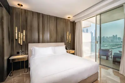 a bedroom with a white bed and a large window at FIVE Palm Jumeirah Hotel Apartments in Dubai