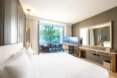 a bedroom with a large white bed and a large mirror at FIVE Palm Jumeirah Hotel Apartments in Dubai