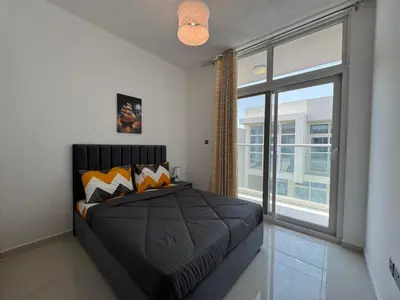 a bedroom with a bed and a large window at 3 Bedroom Villa in Vardon Cluster Damac Hills 2 Peaceful Family Retreat By al sarya Holiday Homes in Dubai