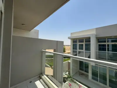 an outside view of a building with a balcony at 3 Bedroom Villa in Vardon Cluster Damac Hills 2 Peaceful Family Retreat By al sarya Holiday Homes in Dubai