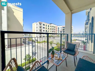 a balcony with chairs and a table on a balcony at HiGuests - Soothing Seaside 2 BR Haven in La Mer in Dubai