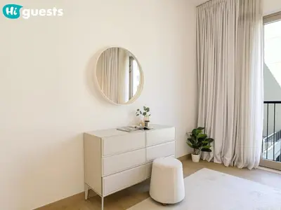 a white dresser in a white room with a mirror at HiGuests - Soothing Seaside 2 BR Haven in La Mer in Dubai