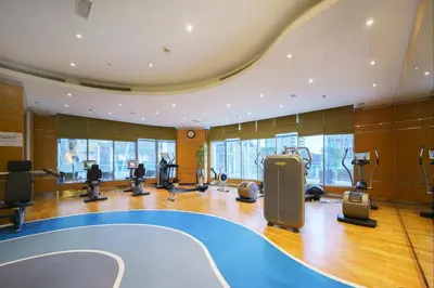 a gym with a elliptical gymnasium with exercise equipment at Damac Maison Mall Street! 2 Bedroom, 1-minute to Dubai Mall! in Dubai