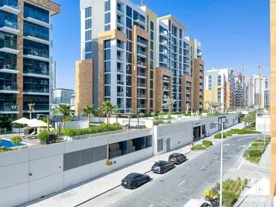 an aerial view of a street with parked cars at Charming Studio with Balcony in Azizi Riviera in Dubai