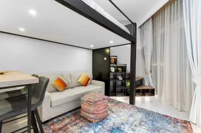a living room with a couch and a table at Miami Vibes | Canal View | Fully Furnished Studio in Dubai