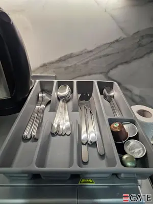 a tray with silver utensils on a table at EGATE - Studio - 10th Floor - Balcony with a View - 01-1014 in Dubai
