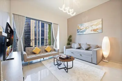 a living room with a couch and a table at Luxury Grande Suites by Hostiva - Full Burj Khalifa View in Dubai