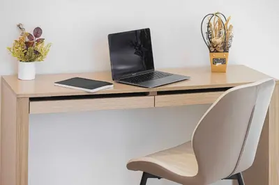 a laptop computer sitting on a wooden desk with a chair at Luxury Grande Suites by Hostiva - Full Burj Khalifa View in Dubai