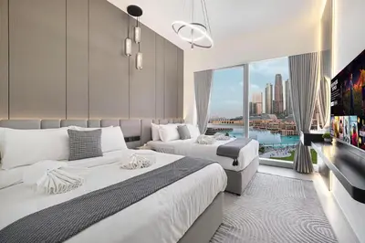 a hotel room with two beds and a large window at Luxury Grande Suites by Hostiva - Full Burj Khalifa View in Dubai