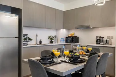 a kitchen with a table with glasses of orange juice at Luxury Grande Suites by Hostiva - Full Burj Khalifa View in Dubai