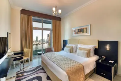 a hotel room with a bed and a large window at Luxury Casa - Marina Diamond 2 in Dubai