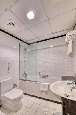 a bathroom with a toilet and a sink and a tub at Luxury Casa - Marina Diamond 2 in Dubai