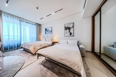 two beds in a room with a large window at Trillionaire Business Bay with Private Jacuzzi in Dubai
