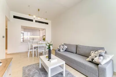 a living room with a couch and a table at PVH - Cosy 2BR Plus Study - Binghatti Crescent in Dubai