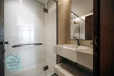 a bathroom with a sink and a glass shower at Luxurious - Comfy 2BR in Business Bay - City Views in Dubai