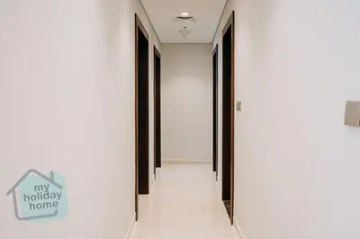 a hallway with black doors and a sign on the wall at Luxurious - Comfy 2BR in Business Bay - City Views in Dubai