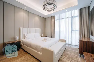 a bedroom with a large bed and a large window at Luxurious - Comfy 2BR in Business Bay - City Views in Dubai