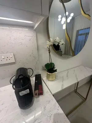 a bathroom counter with a mirror and a sink at Brand new apartment next to Burj Al Arb in Dubai