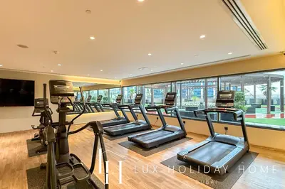 a gym with rows of treadmills in a building at LUX The Burj Khalifa Downtown View Studio 2 in Dubai