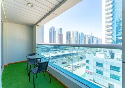 a balcony with a table and chairs and a view of a city at 1BR Elegant Apartment in Marina Diamond 3 Metro Access in Dubai