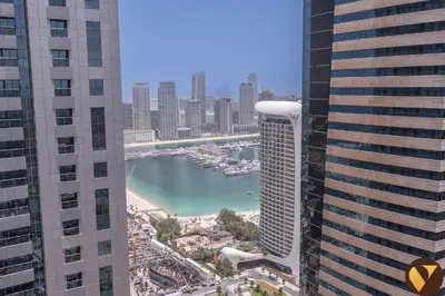 a view of a river between two tall buildings at Vogue Marina Torch Tower near JBR Beach and Dubai Marina Mall, Two Bedroom Apartment with Balcony and City Skyline View, Access to all Amenities in Dubai