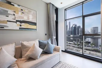 a living room with a couch and a large window at DVR 2BR in 15 Northside Business bay in Dubai