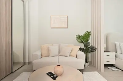 a living room with a couch and a table at Brand New Luxury Stays by Edora at Sway Residence Dubai Hills in Dubai