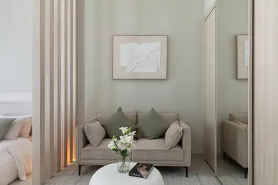 a living room with a couch and a table at Brand New Luxury Stays by Edora at Sway Residence Dubai Hills in Dubai