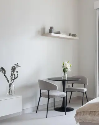 a dining room with a table and two chairs at Brand New Luxury Stays by Edora at Sway Residence Dubai Hills in Dubai