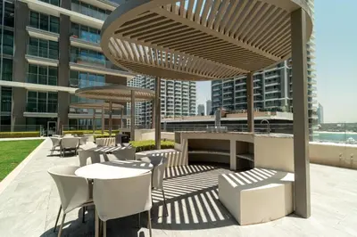 a patio with tables and chairs on a building at Golden Coast Stay in Dubai