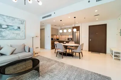 a living room with a couch and a table at Golden Coast Stay in Dubai
