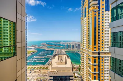a view of a city from between two tall buildings at Daniels 3BR with Palm View at Marina Pinnacle in Dubai
