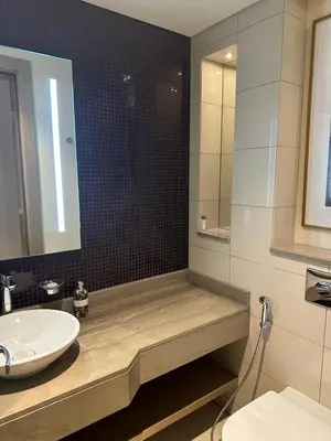 a bathroom with a sink and a mirror at 4905 Luxury View By Royal Sky Vacation Homes Paramount Tower A in Dubai
