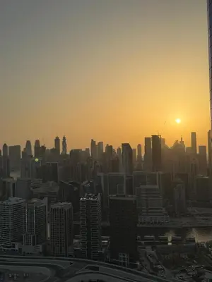 a view of a city skyline at sunset at 4905 Luxury View By Royal Sky Vacation Homes Paramount Tower A in Dubai