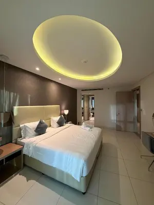 a bedroom with a large bed with a large ceiling at 4905 Luxury View By Royal Sky Vacation Homes Paramount Tower A in Dubai