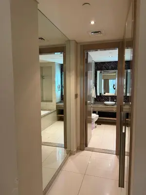 a hallway with mirrors and a bathroom with a sink at 4905 Luxury View By Royal Sky Vacation Homes Paramount Tower A in Dubai