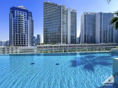 a large swimming pool in front of some tall buildings at Streling Studio with Balcony & City Views in Dubai