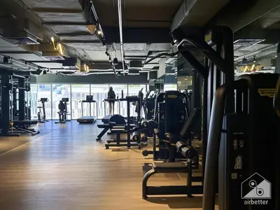 a gym with lots of cardio equipment and people exercising at Streling Studio with Balcony & City Views in Dubai
