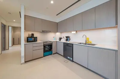 a kitchen with a sink and a stove top oven at Luxury Stay with Burj views in Dubai