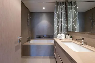 a bathroom with a tub and a large sink at Luxury Stay with Burj views in Dubai