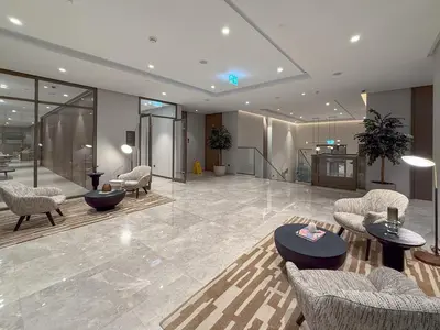 a lobby with chairs and tables in a building at Luxury Stay with Burj views in Dubai